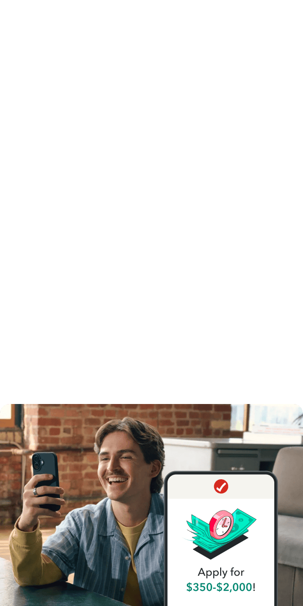 TurboTax customer Vanessa smiles as she looks at her phone.