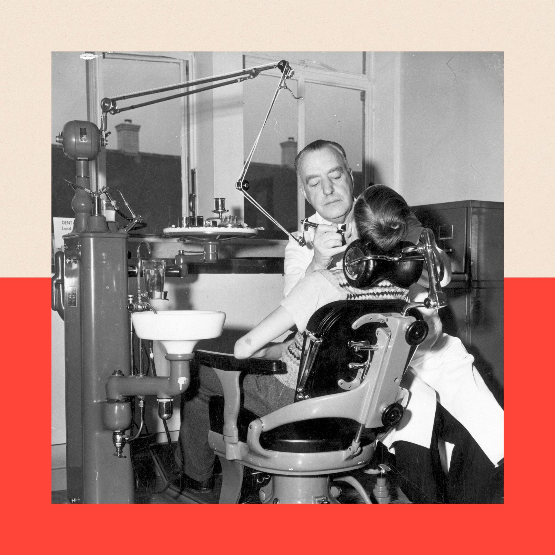 A black-and-white image of a dentist treating a child