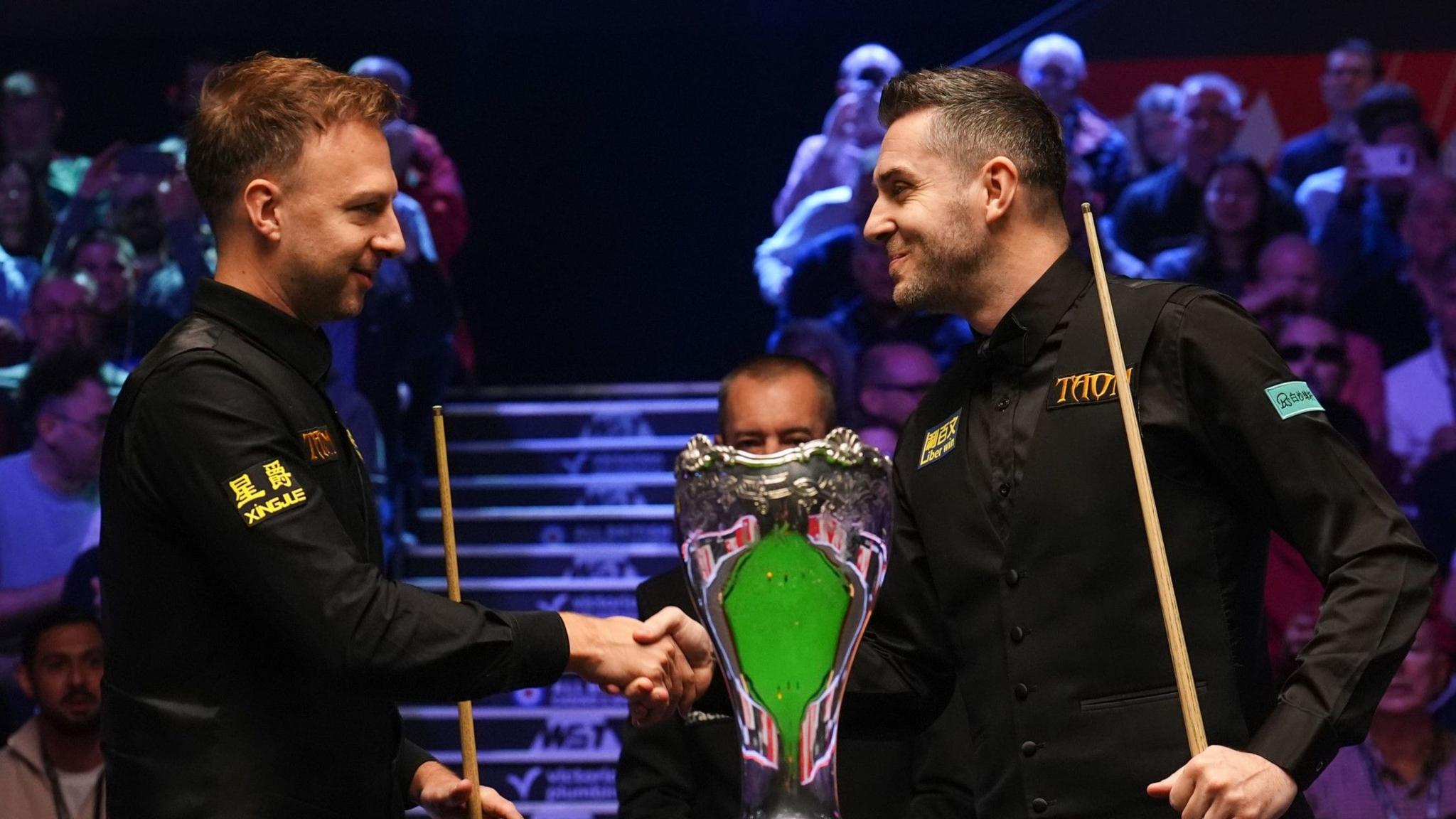 Judd Trump and Mark Selby shake hands