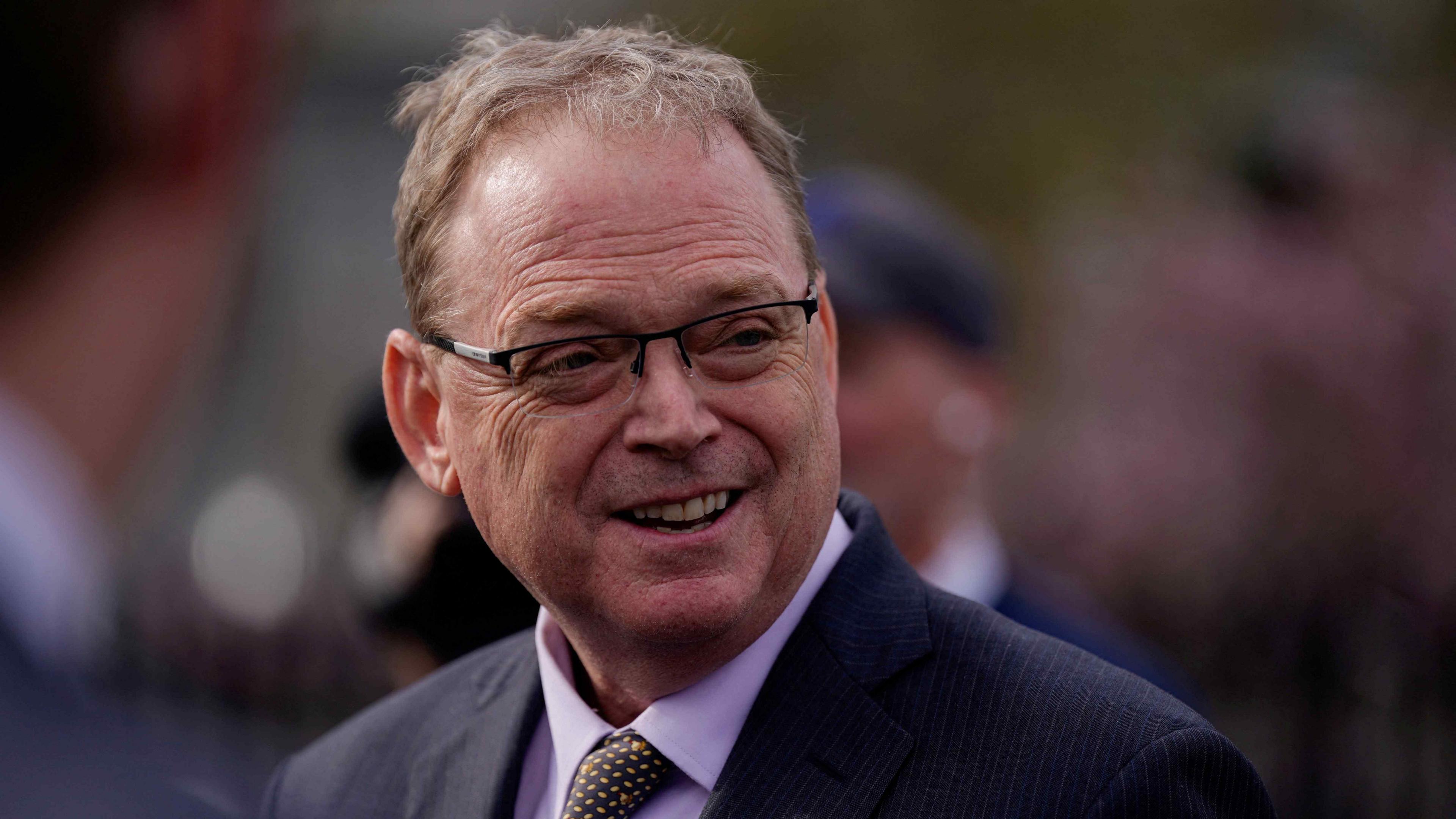 Kevin Hassett, wearing glasses looks to the side of the camera.