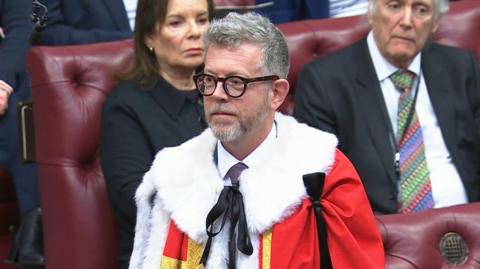 Lord Doyle is introduced to the House of Lords in January 2026. He is wearing a ceremonial red robe with a white fur collar.