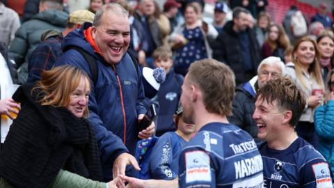Oscar Lennon and Kieran Marmion of Bristol Bears smile as they greet fans who are in the front row of the stands in Ashton Gate after the win over Exeter. Other fans are looking on in the background