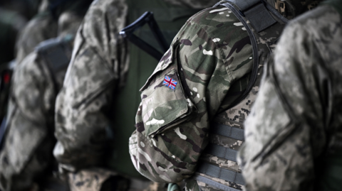 A photo of anonymous soldiers. The UK flag can be seen on the side of the arm of one of the soldier's uniforms