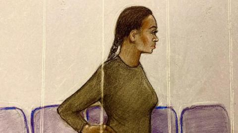 A pencil drawing of a woman with her dark hair in a plat and a brownish top. She is drawn side on with court chairs in the background.