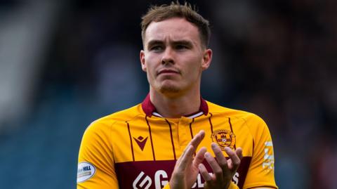 Kofi Balmer, pictured in a Motherwell kit, clapping fans