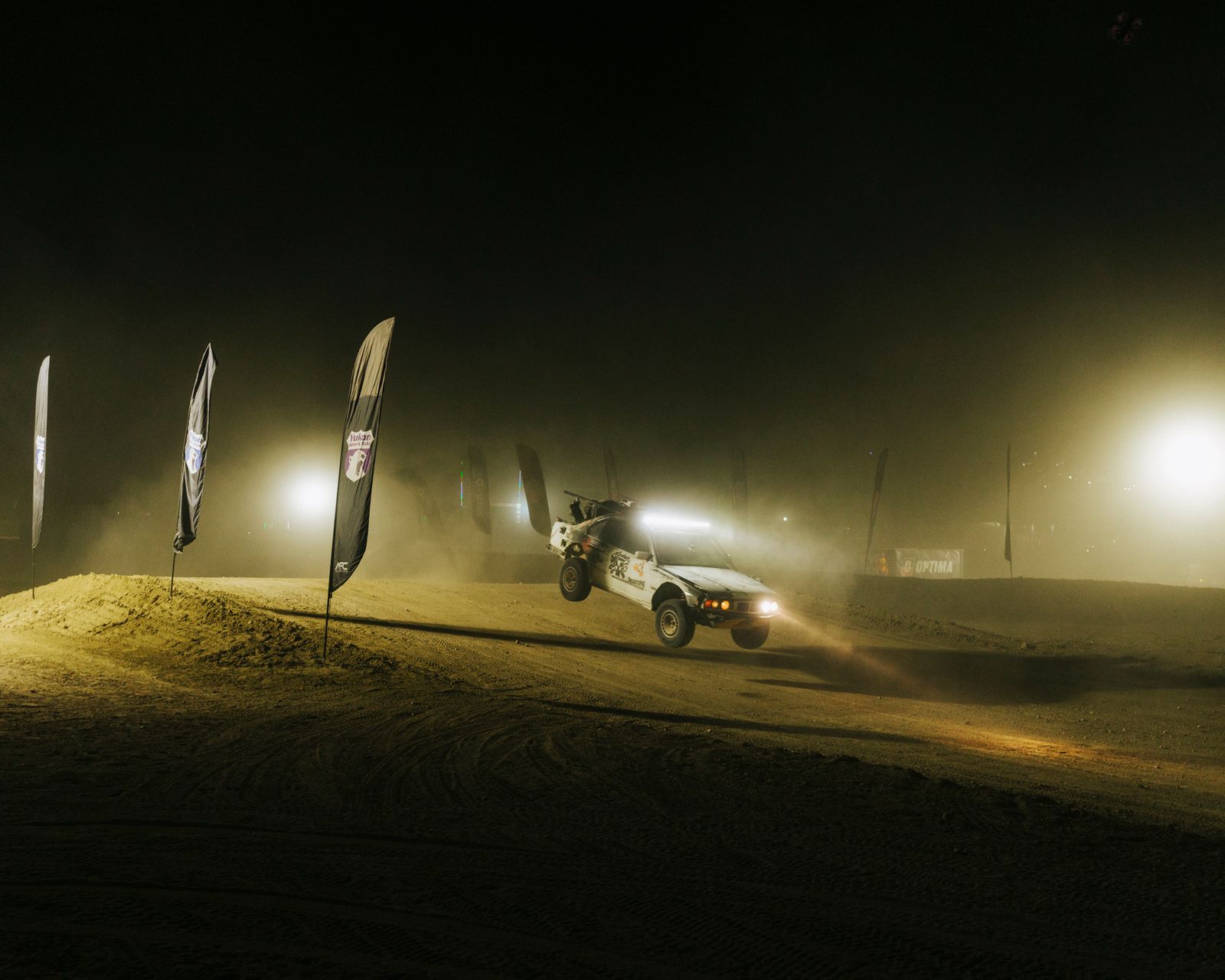 A BMW E30 catches air at the HooptieX race—a lighthearted alternative to the milliondollar builds seen in some of the...