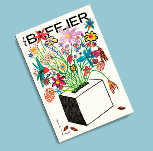 The front cover of the magazine. It features a tissue box with a colorful bouquet of flowers coming out of it.